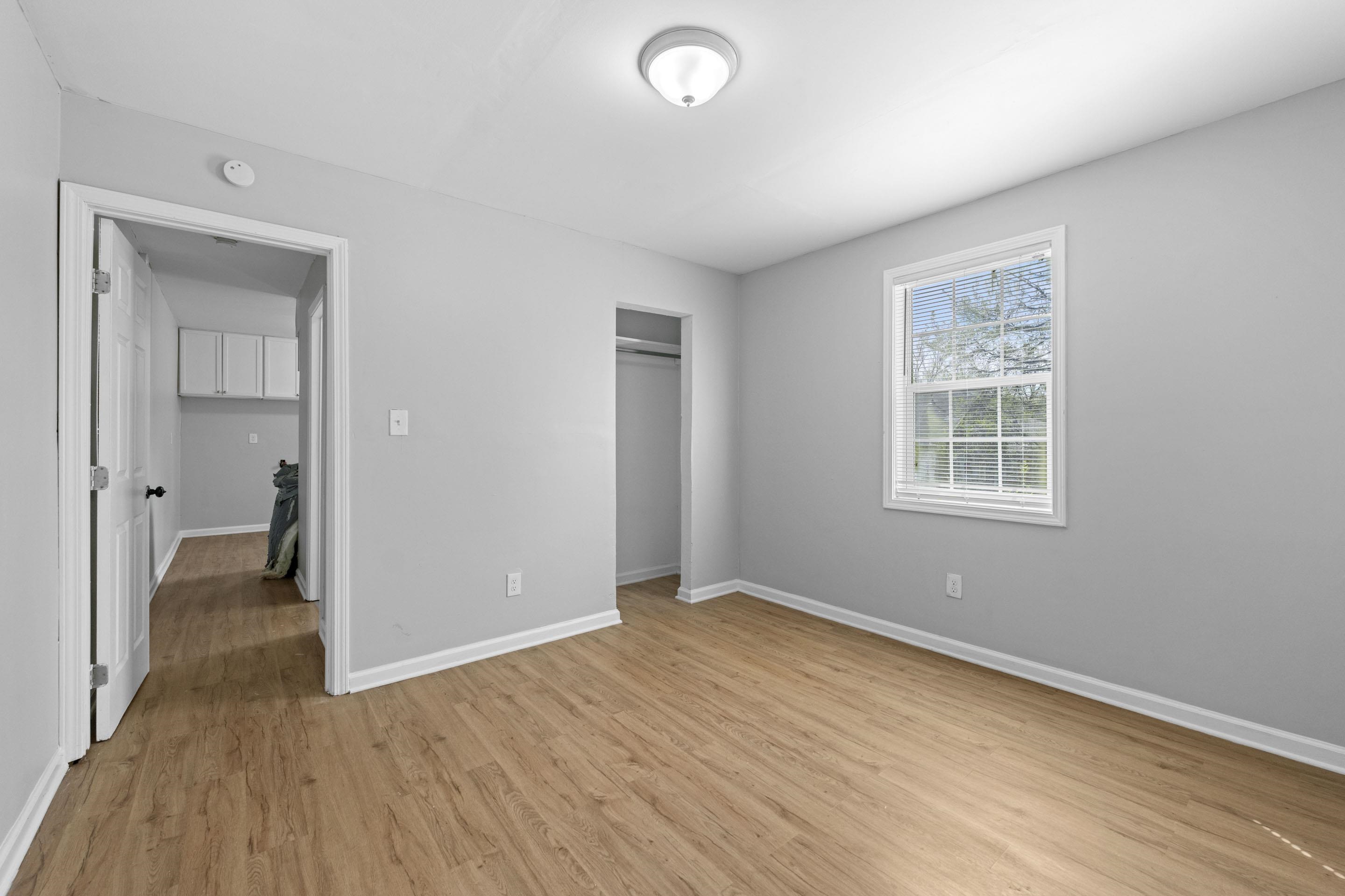 1493 Gaither Street Memphis, TN 38106 - Photo 21 of 27 wooden floor in an empty room with a window