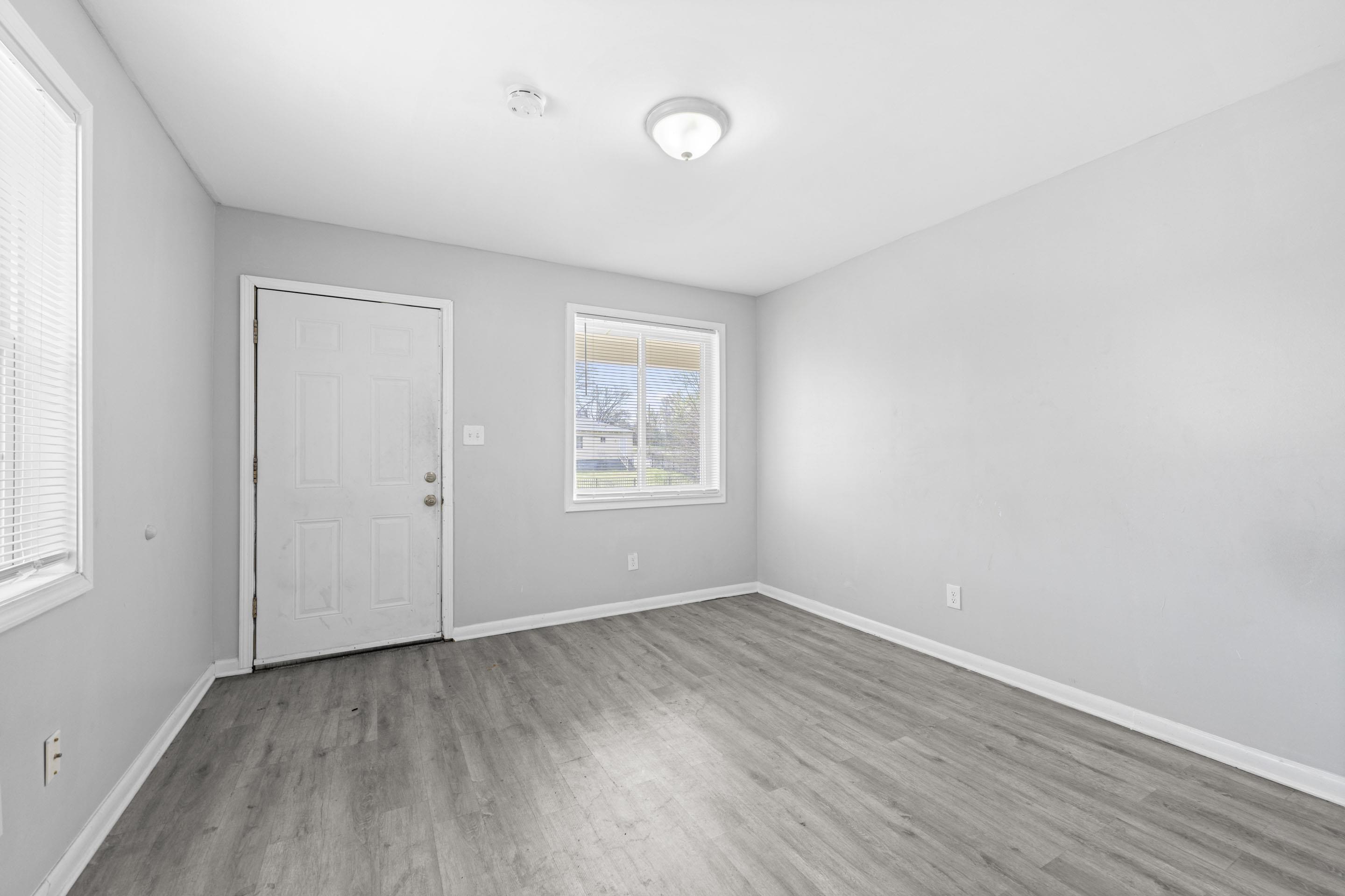 1493 Gaither Street Memphis, TN 38106 - Photo 22 of 27 an empty room with wooden floor and windows