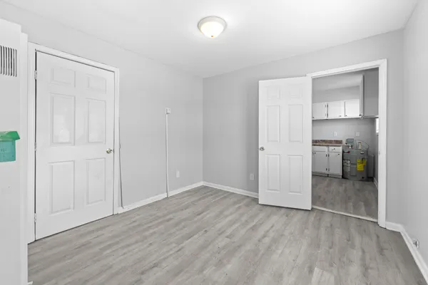 a view of a room with wooden floor and white walls