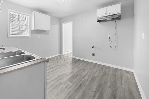 a view of an empty room with wooden floor