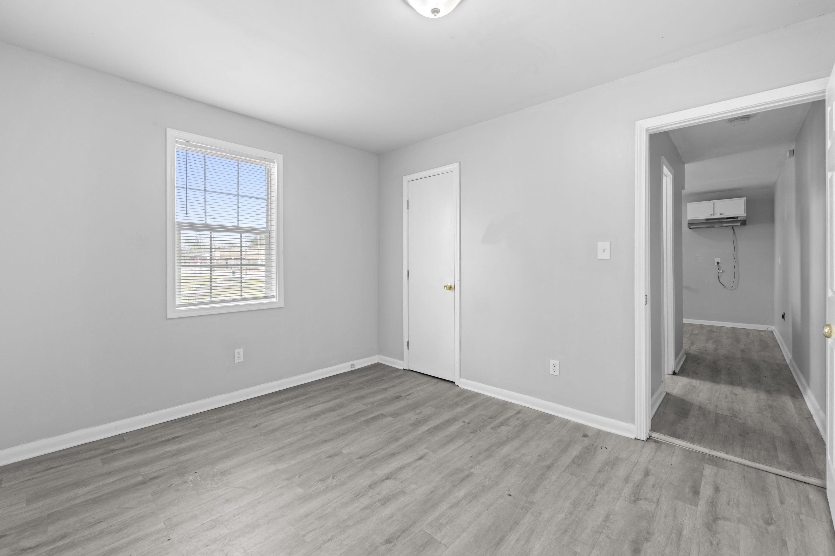 1493 Gaither Street Memphis, TN 38106 - Photo 26 of 27 a view of an empty room with wooden floor and a window