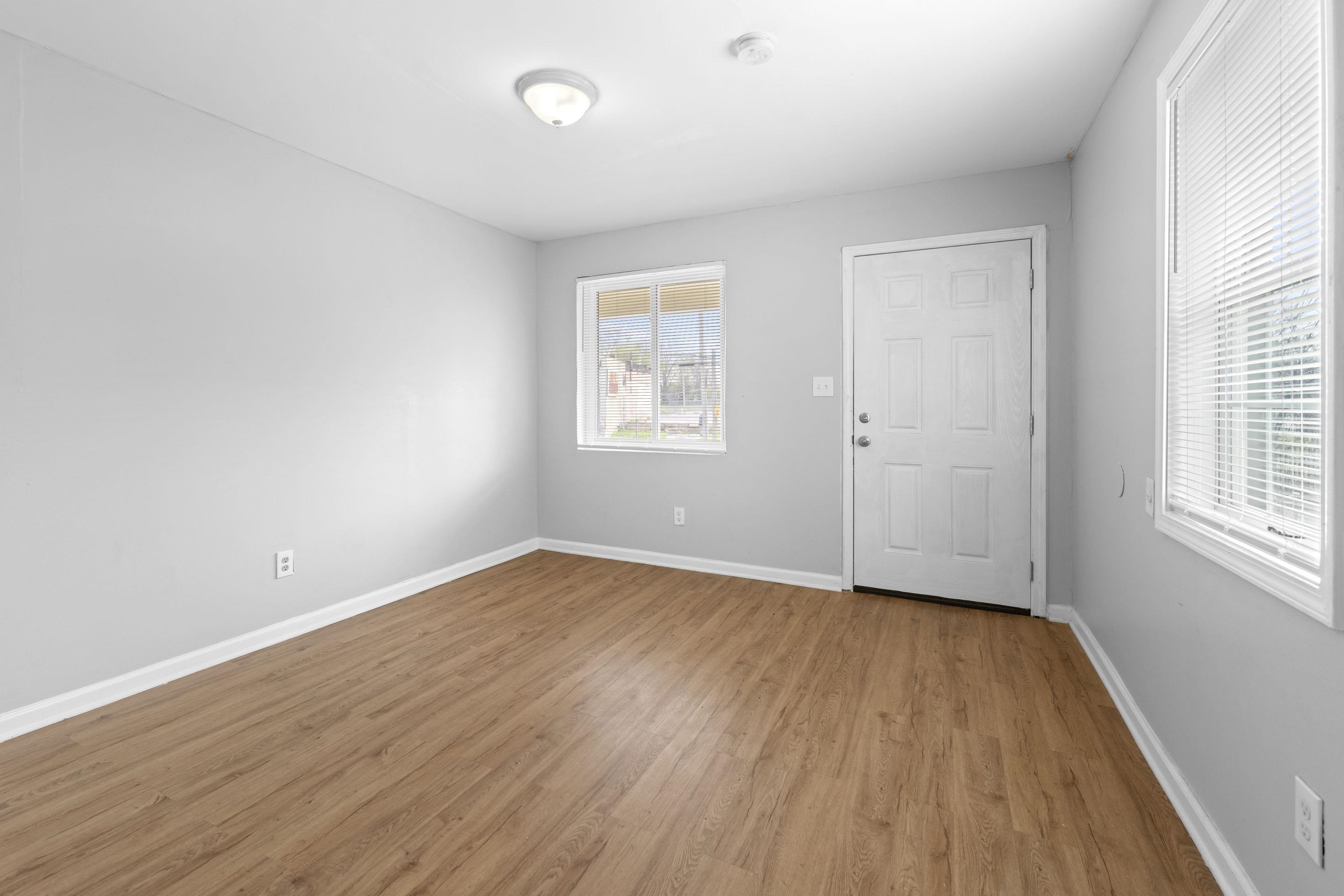1493 Gaither Street Memphis, TN 38106 - Photo 4 of 27 an empty room with wooden floor and windows