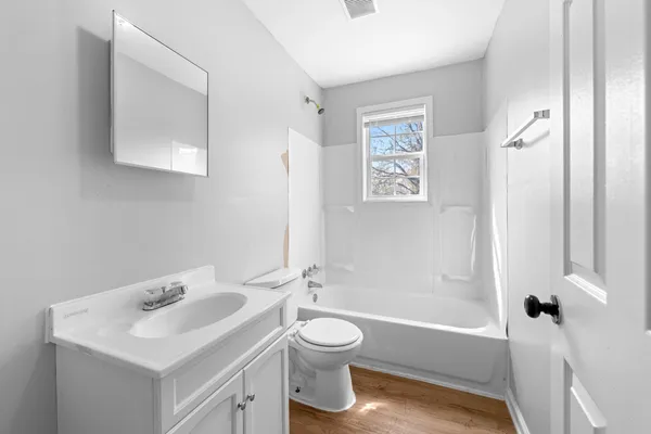 a bathroom with a sink toilet tub and shower