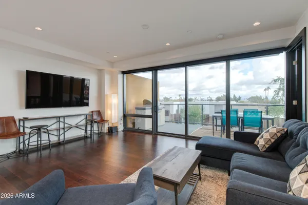 a living room with fireplace furniture and a flat screen tv