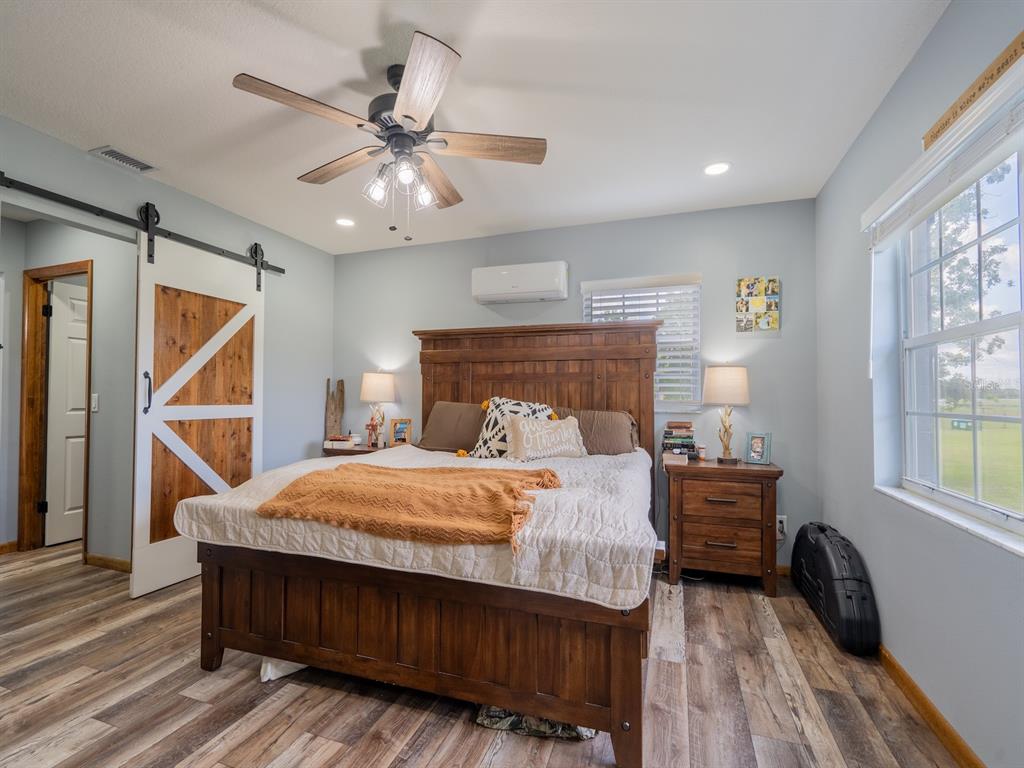 4381 Northeast 105th Place Anthony, FL 32617 - Photo 21 of 49 a bedroom with a bed and a chandelier