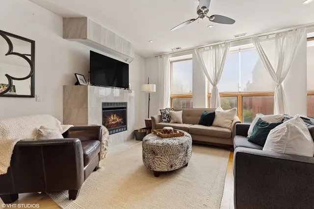a living room with furniture a flat screen tv and a fireplace