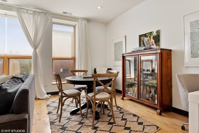 a view of a dining room with furniture and a window
