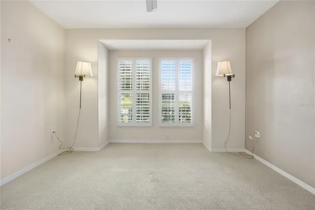 a view of an empty room and a ceiling fan