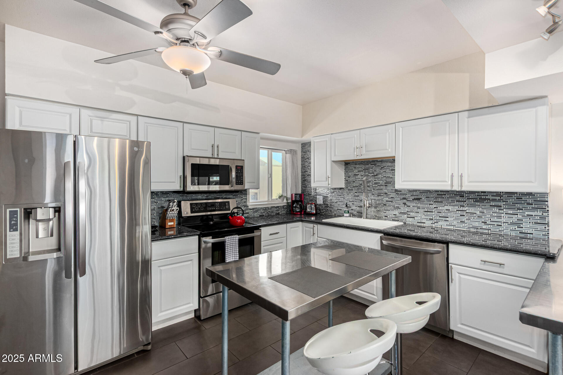 351 East Thomas Road, Unit D505 Phoenix, AZ 85012 - Photo 4 of 28 a kitchen with white cabinets stainless steel appliances and a counter space