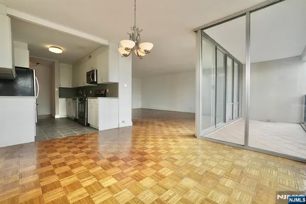 a view of a kitchen with a sink and refrigerator in it