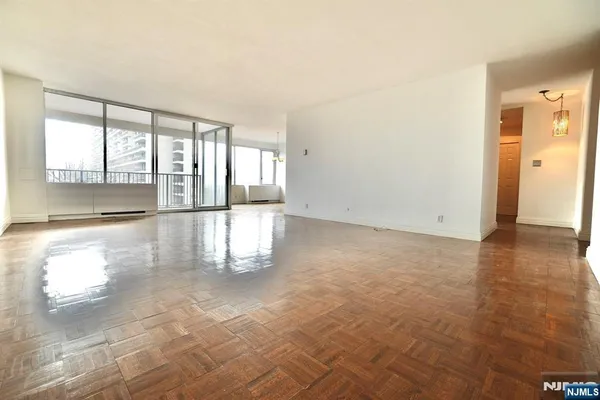 an empty room with large windows
