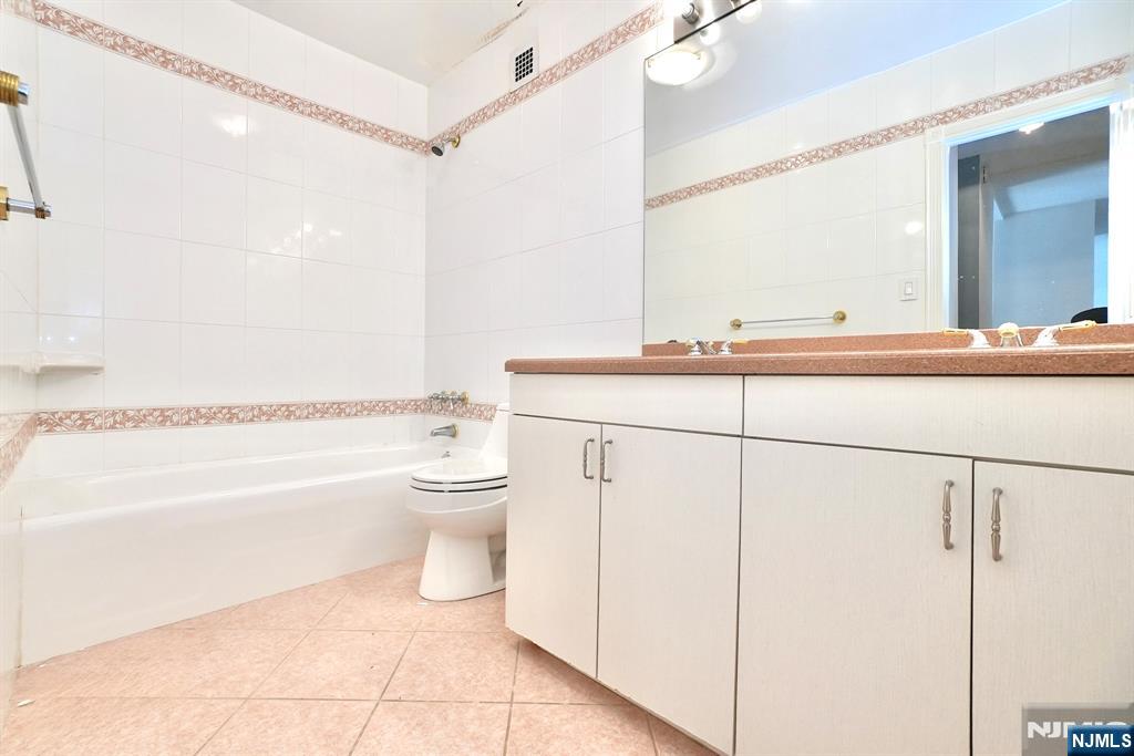 5 Horizon Road, Unit 203 Fort Lee, NJ 07024 - Photo 19 of 27 a bathroom with a toilet a sink and a bathtub