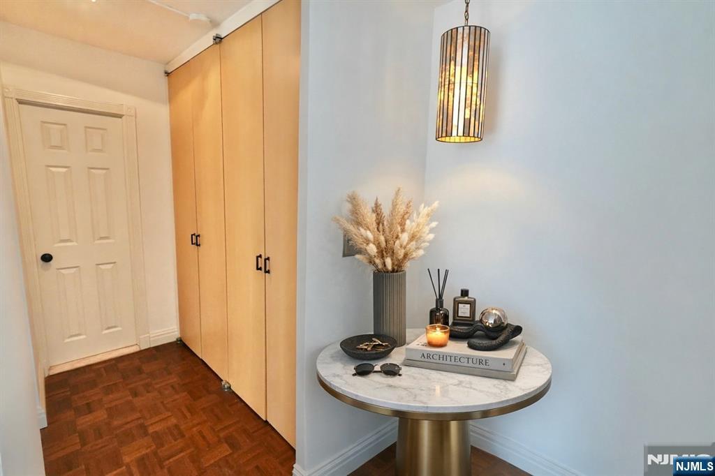 5 Horizon Road, Unit 203 Fort Lee, NJ 07024 - Photo 2 of 27 a dining room with furniture and wooden floor