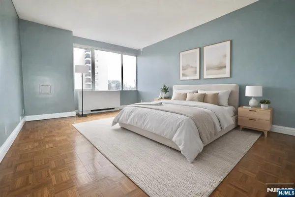 a bedroom with a large bed and a window