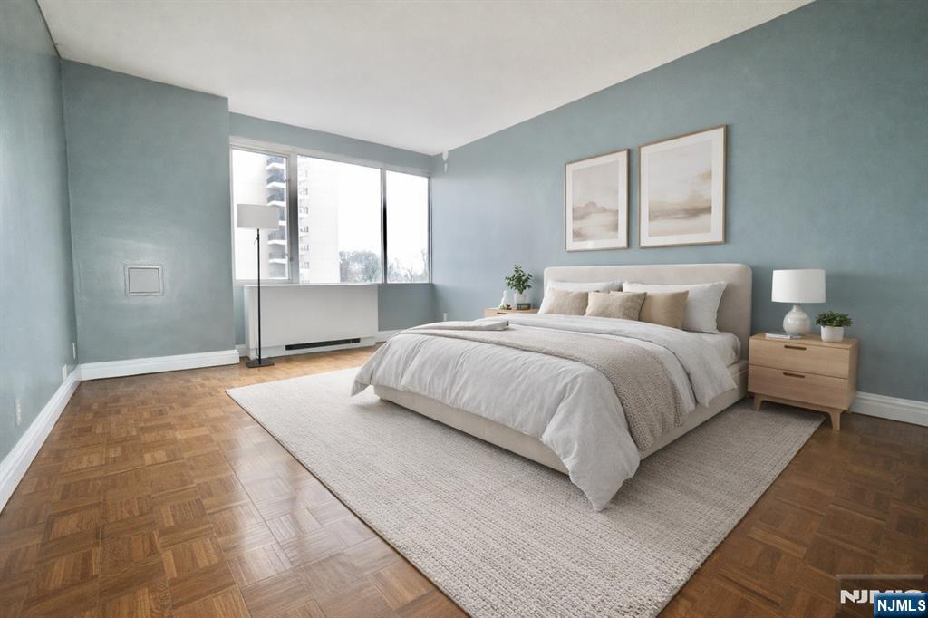 5 Horizon Road, Unit 203 Fort Lee, NJ 07024 - Photo 6 of 27 a bedroom with a large bed and a window