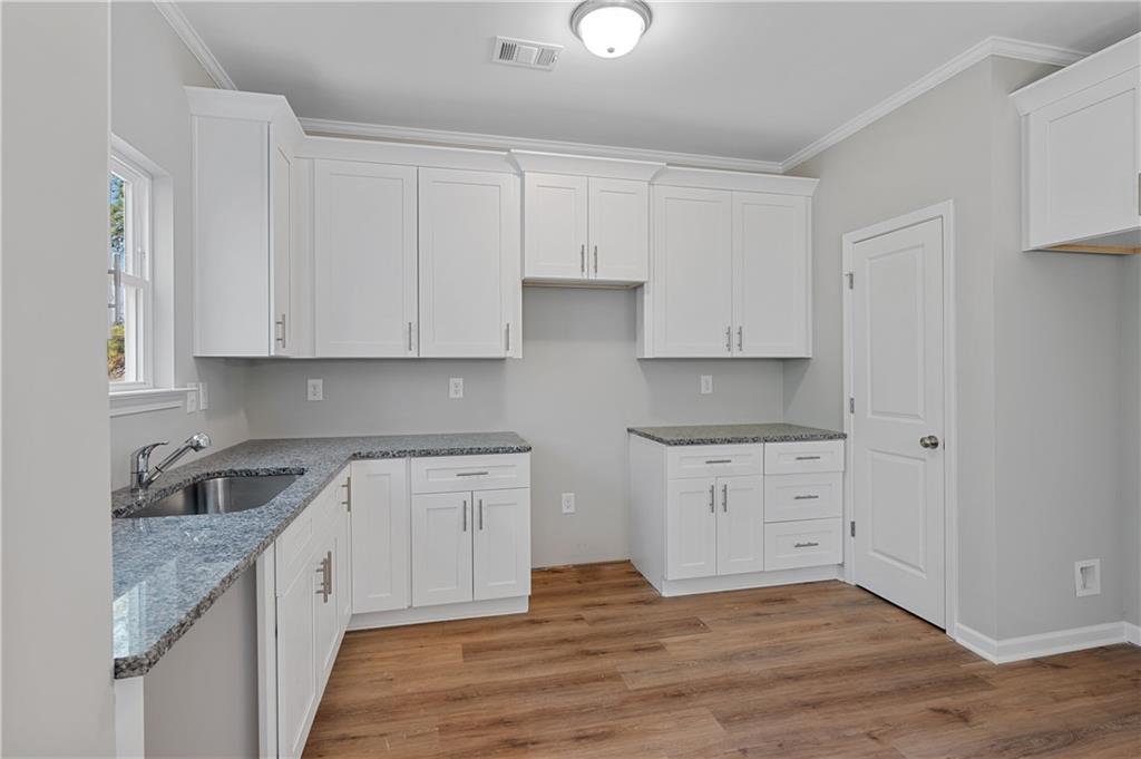 2832 Laurel Ridge Circle Atlanta, GA 30344 - Photo 11 of 28 a kitchen with granite countertop white cabinets and a sink
