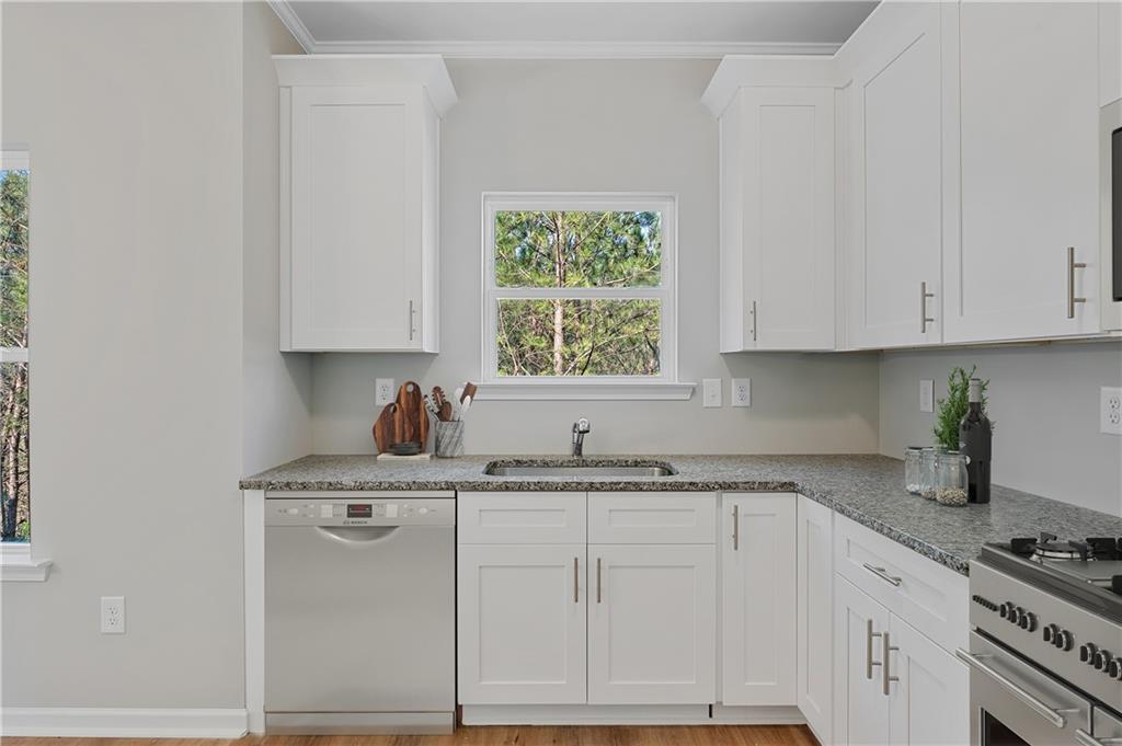 2832 Laurel Ridge Circle Atlanta, GA 30344 - Photo 15 of 28 a kitchen with granite countertop a sink cabinets and window
