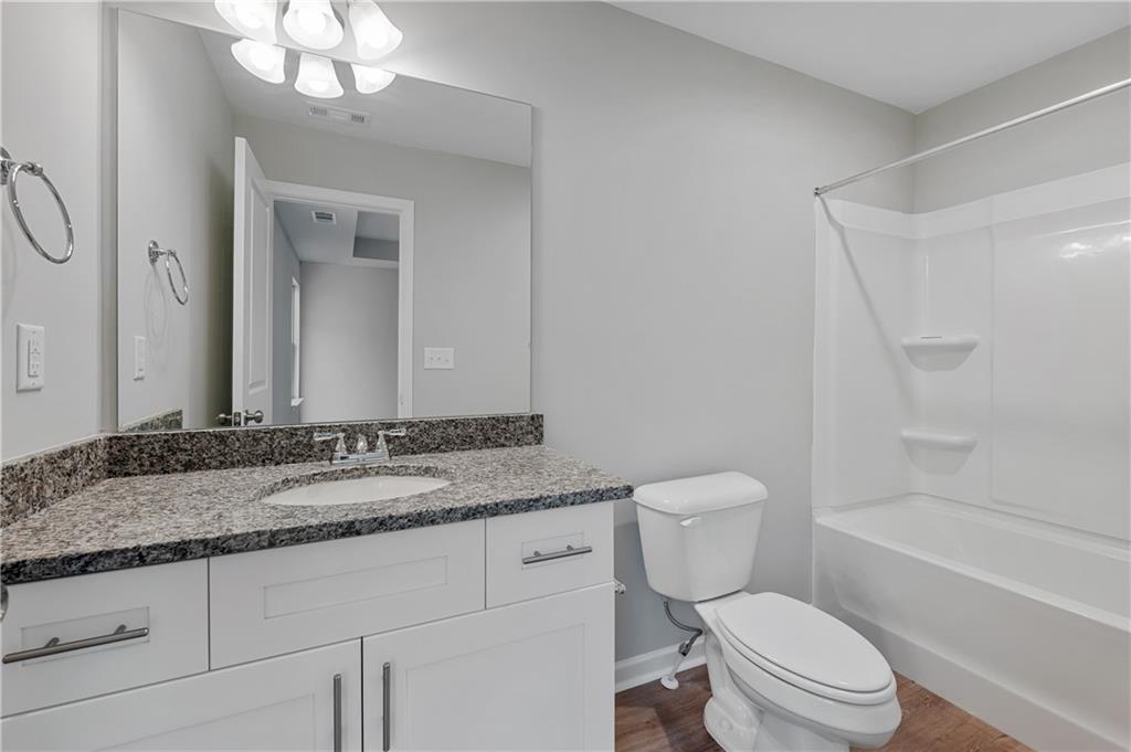 2832 Laurel Ridge Circle Atlanta, GA 30344 - Photo 20 of 28 a bathroom with a granite countertop toilet sink and mirror