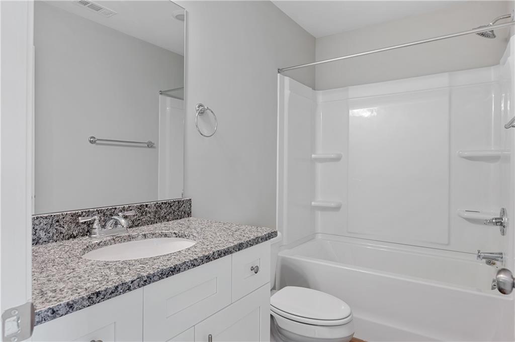 2832 Laurel Ridge Circle Atlanta, GA 30344 - Photo 24 of 28 a bathroom with a granite countertop sink toilet and shower