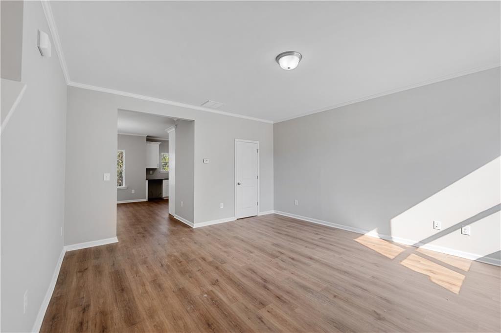 2832 Laurel Ridge Circle Atlanta, GA 30344 - Photo 4 of 28 a view of an empty room with wooden floor and a window