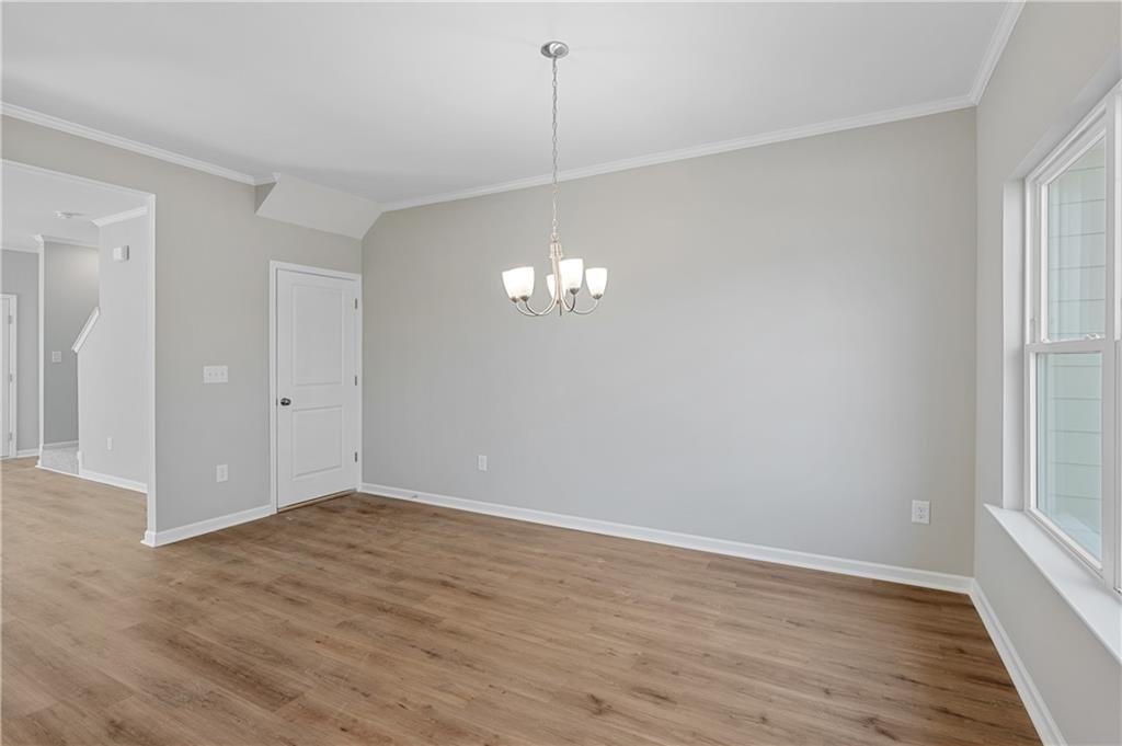 2832 Laurel Ridge Circle Atlanta, GA 30344 - Photo 7 of 28 wooden floor in an empty room with a window