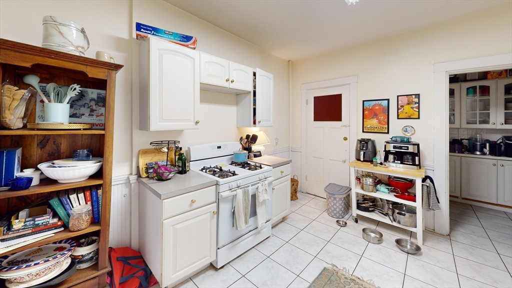 1213 Beacon Street, Unit 4 Brookline, MA 02446 - Photo 9 of 11 a room with furniture and a book shelf