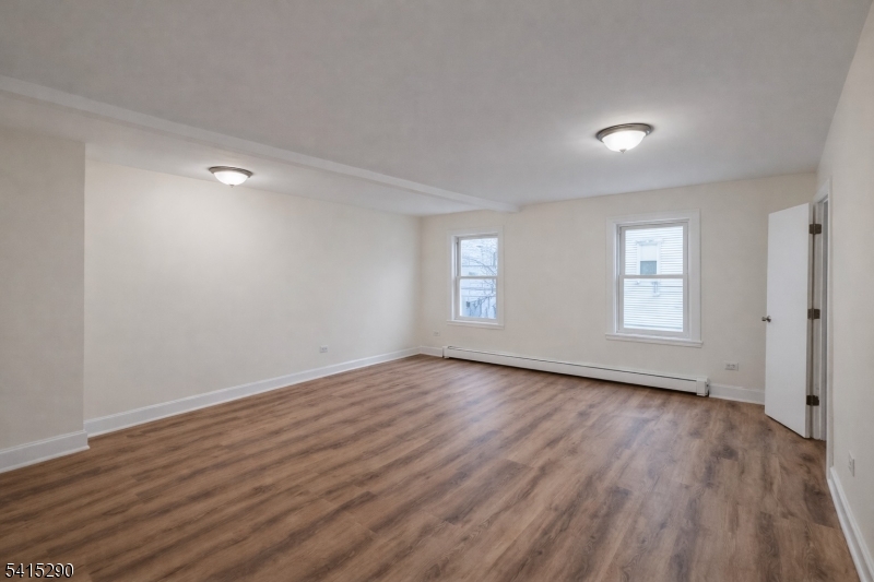 64 North 13th Street, Unit 2 Newark, NJ 07107 - Photo 11 of 16 a view of an empty room with wooden floor and window