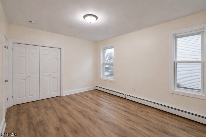 64 North 13th Street, Unit 2 Newark, NJ 07107 - Photo 13 of 16 wooden floor in an empty room with a window