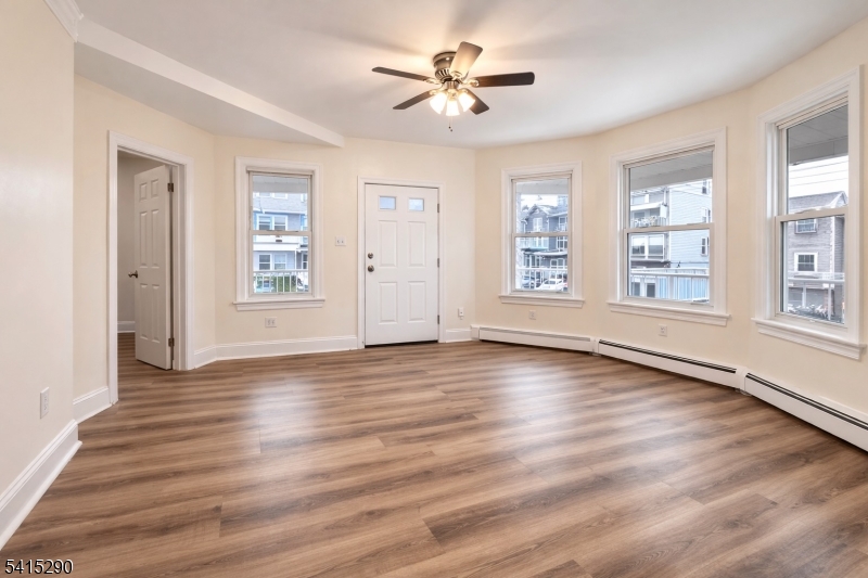 64 North 13th Street, Unit 2 Newark, NJ 07107 - Photo 3 of 16 a view of an empty room with window and wooden floor