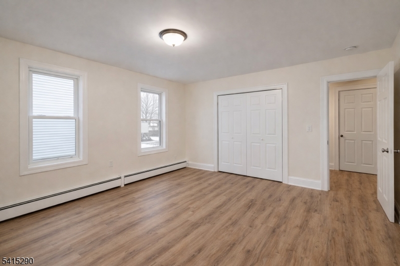 64 North 13th Street, Unit 2 Newark, NJ 07107 - Photo 8 of 16 an empty room with wooden floor and windows