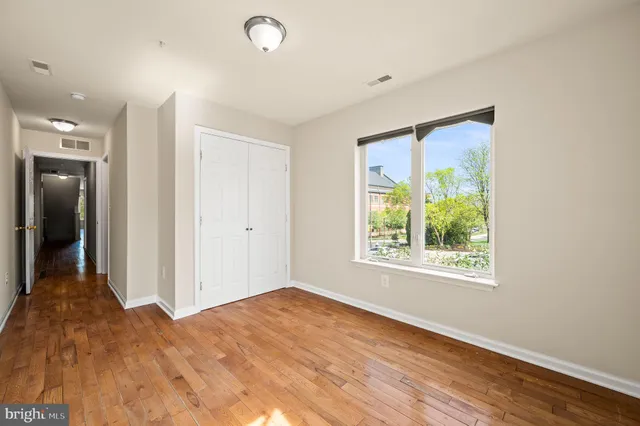 a view of a room with wooden floor and a window