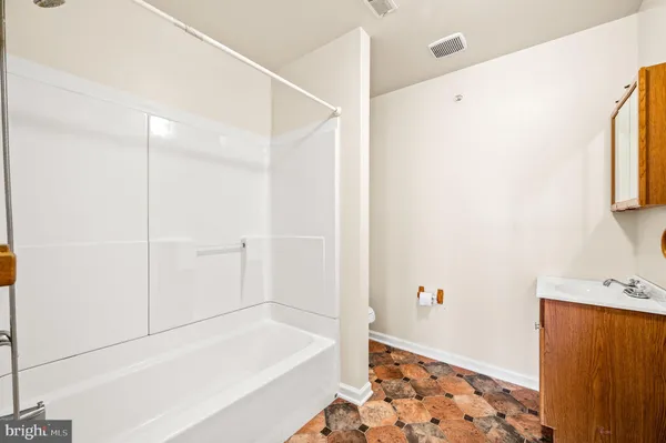 a bathroom with a bathtub and a shower