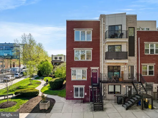 a front view of a residential apartment building with a yard