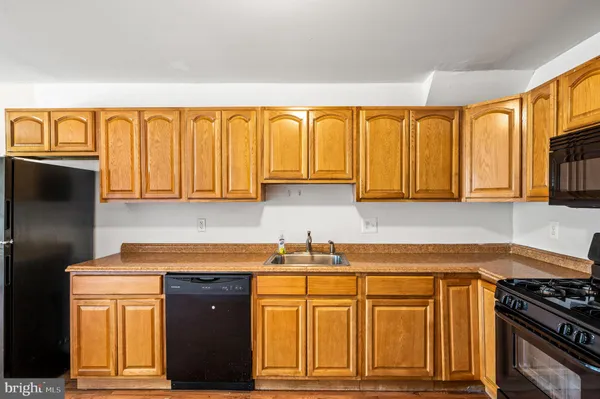 a kitchen with stainless steel appliances granite countertop a refrigerator and sink