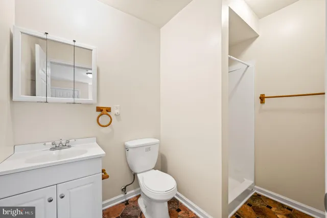a bathroom with a sink mirror vanity and toilet