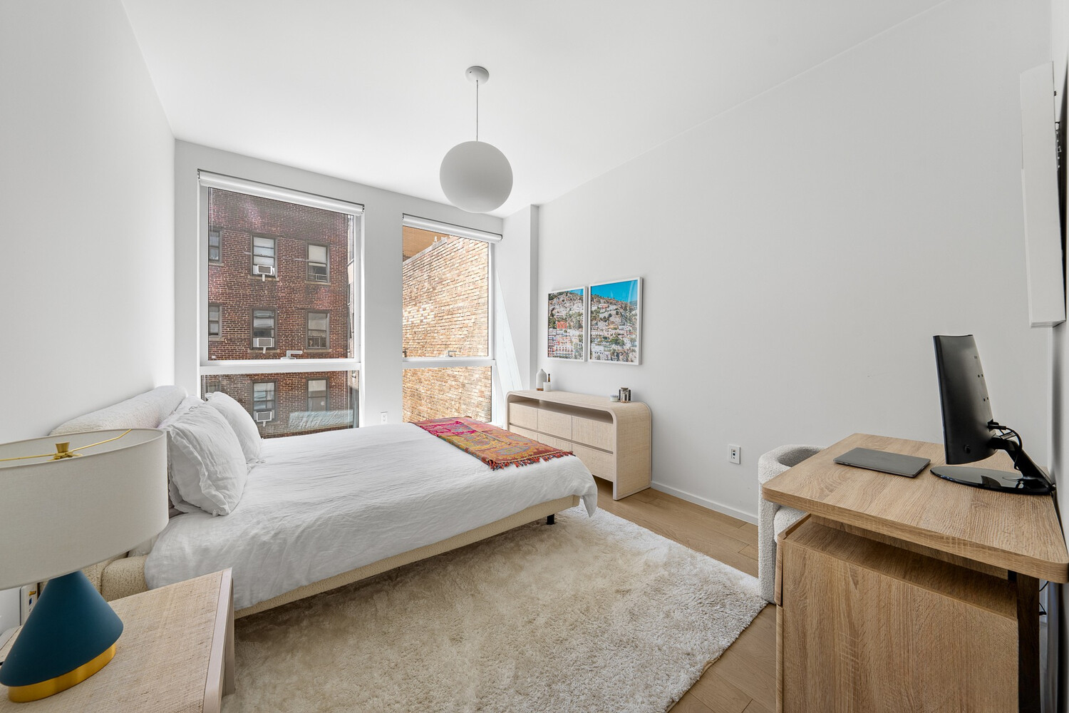 150 East 23rd Street, Unit 4C Manhattan, NY 10010 - Photo 6 of 12 a bedroom with a bed and large window