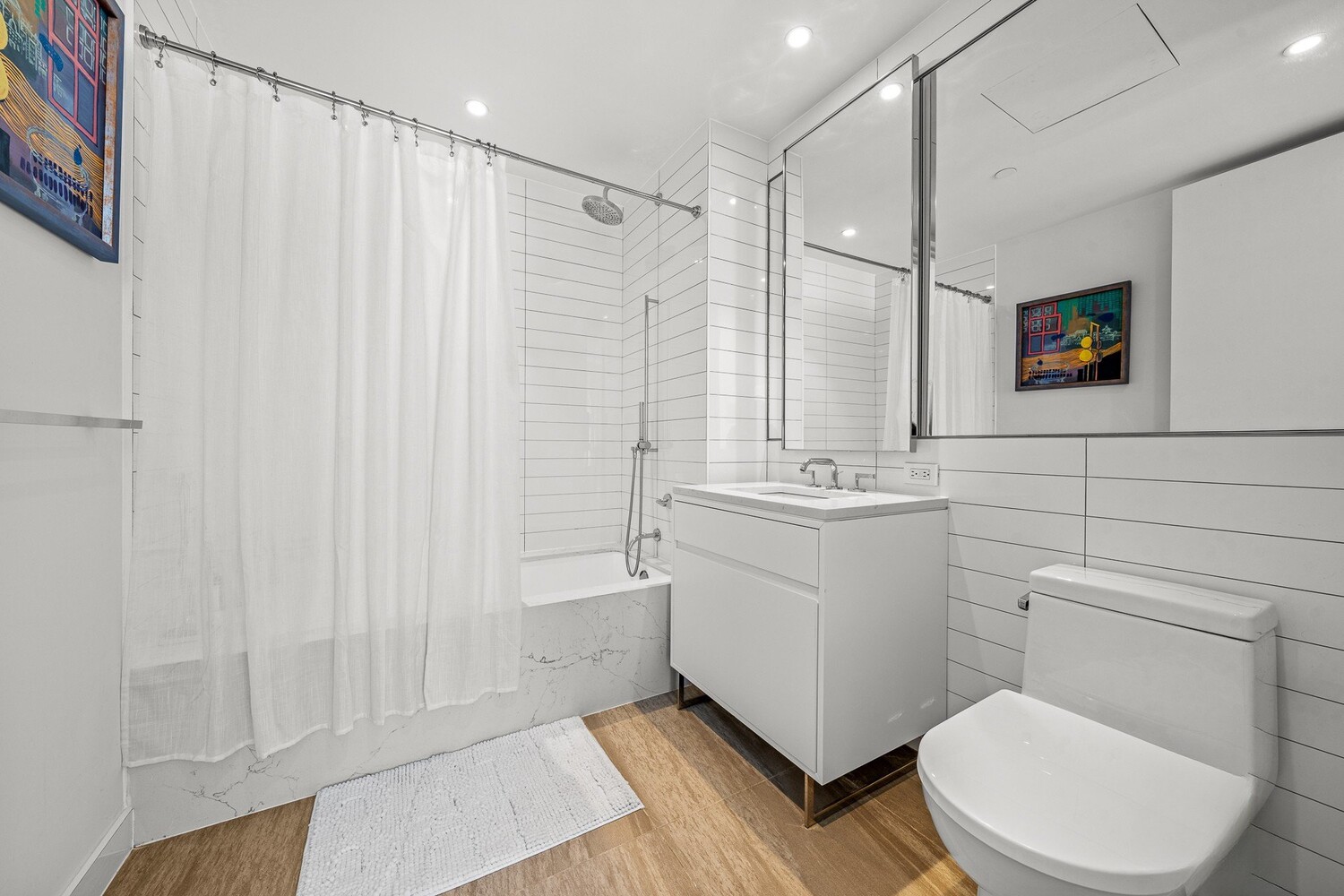 150 East 23rd Street, Unit 4C Manhattan, NY 10010 - Photo 9 of 12 a bathroom with a sink a toilet and shower