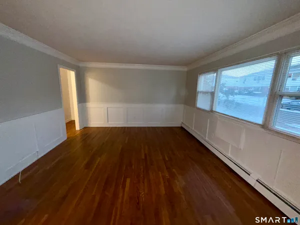 wooden floor in an empty room with a window