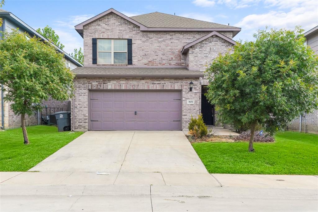 4651 Raleigh Dalton Road Dallas, TX 75227 - Photo 1 of 19 Brick two-story home featuring a spacious driveway, manicured lawn, and mature landscaping