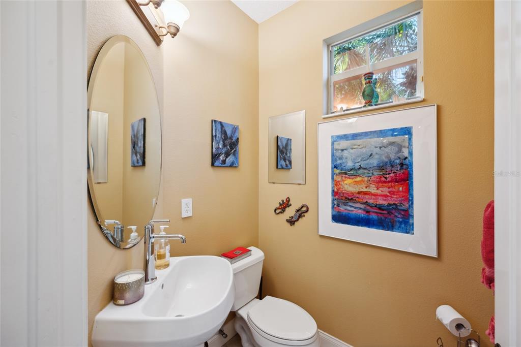 7246 Gaberia Road New Port Richey, FL 34655 - Photo 13 of 45 a bathroom with a toilet a sink and mirror