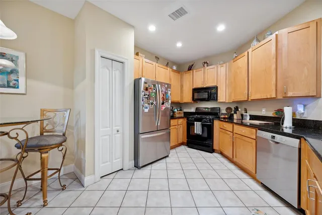 a kitchen with white cabinets and sink