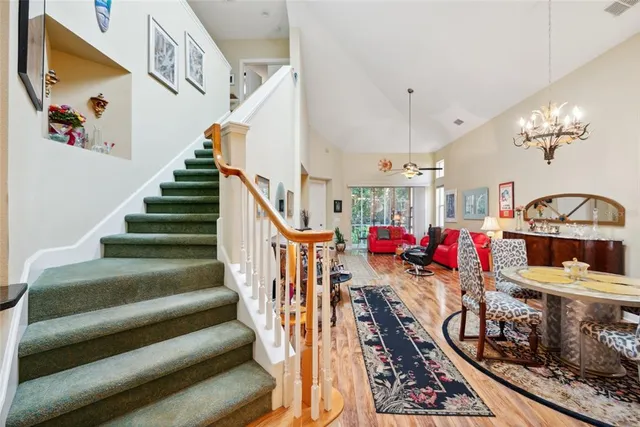 a bedroom with a bed wooden floor and flat screen tv