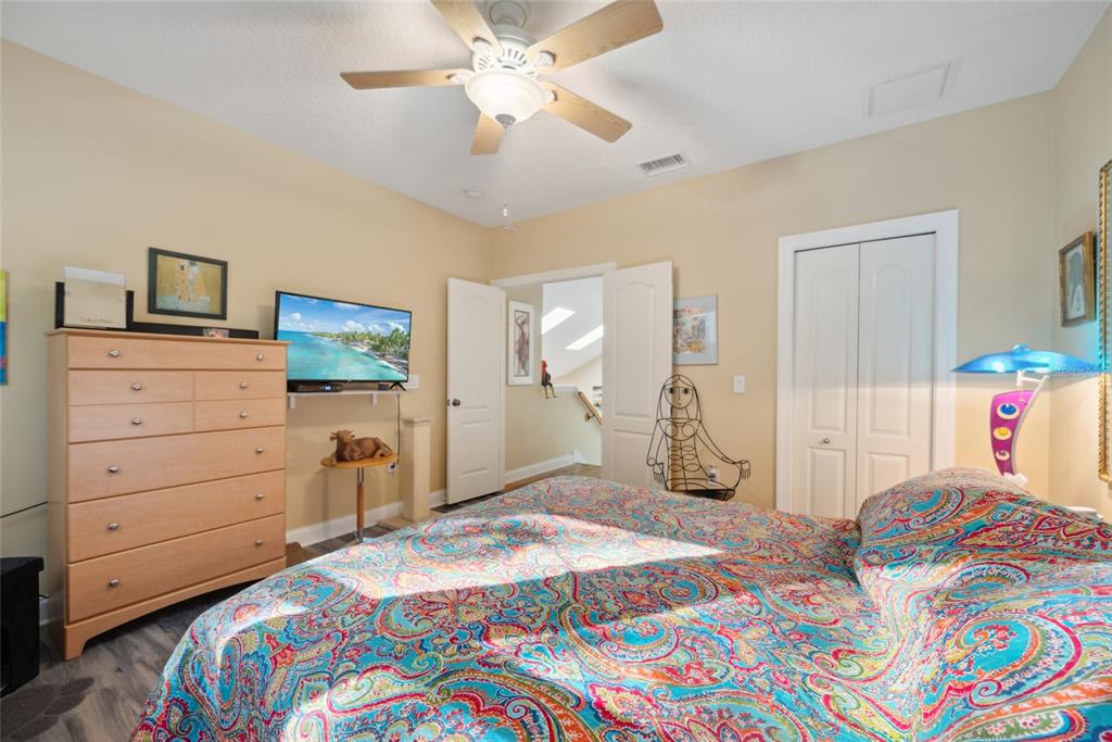 7246 Gaberia Road New Port Richey, FL 34655 - Photo 28 of 45 a bedroom with a bed and a chandelier