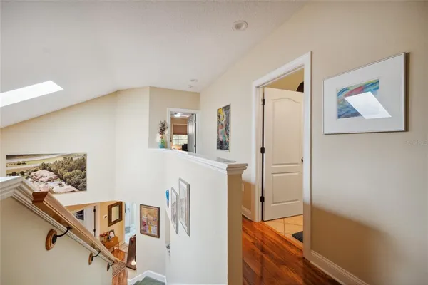a view of a hallway view with wooden floor and staircase