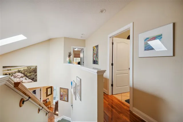 a view of a hallway view with wooden floor and staircase