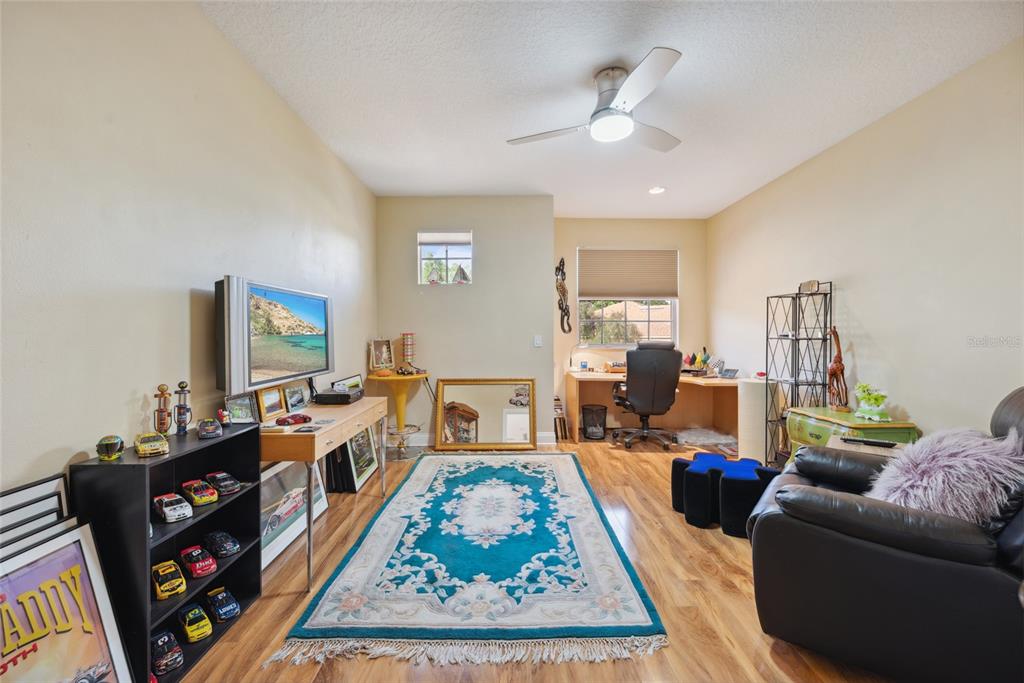 7246 Gaberia Road New Port Richey, FL 34655 - Photo 32 of 45 a living room with furniture a rug and a chandelier