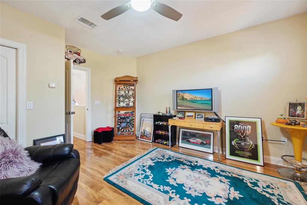 7246 Gaberia Road New Port Richey, FL 34655 - Photo 33 of 45 a living room with furniture and a flat screen tv