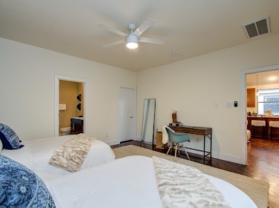 4510 Maxie Street, Unit B Houston, TX 77007 - Photo 12 of 39 a bedroom with a bed and a chandelier