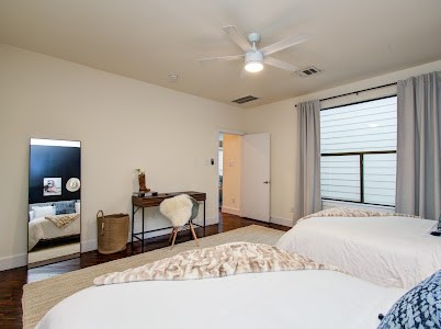 4510 Maxie Street, Unit B Houston, TX 77007 - Photo 14 of 39 a bedroom with a bed and a chandelier