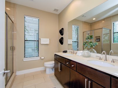 4510 Maxie Street, Unit B Houston, TX 77007 - Photo 16 of 39 a bathroom with a double vanity sink a toilet and a mirror